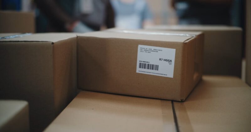 Labeled shipping cartons stacked in a warehouse environment, ready for organized outbound processing